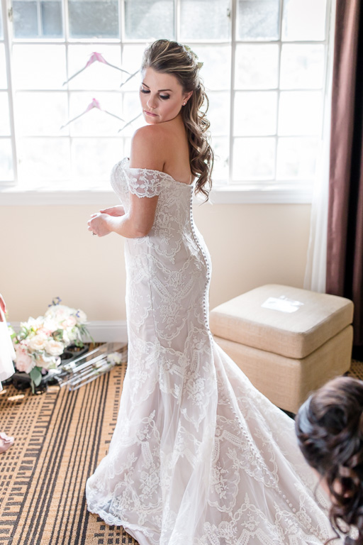bride in her off shoulder A line wedding gown with half up half down hair do
