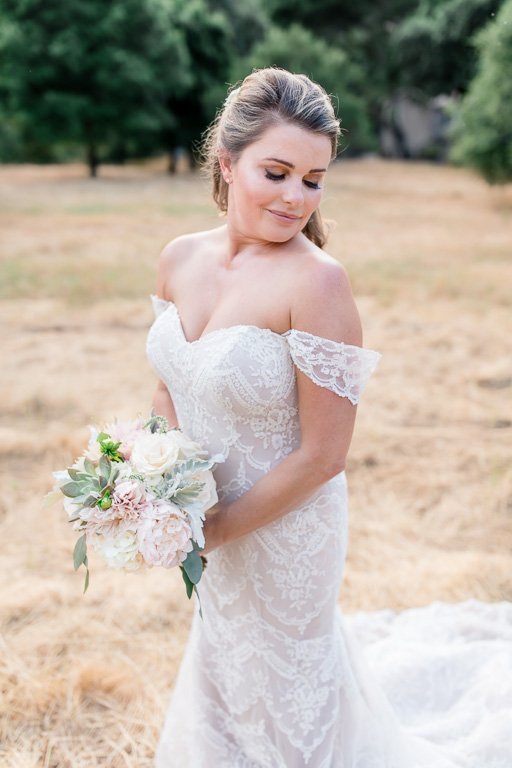 gorgeous bridal portrait on a rolling hill with off shoulder blush wedding gown