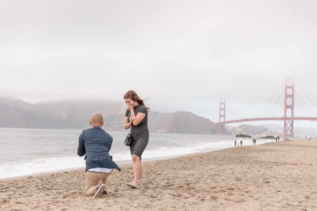 precious surprise proposal reaction caught by camera at baker beach