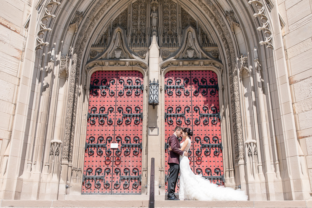 bride and groom wedding portrait at the grand red doors of heinz memorial chapel