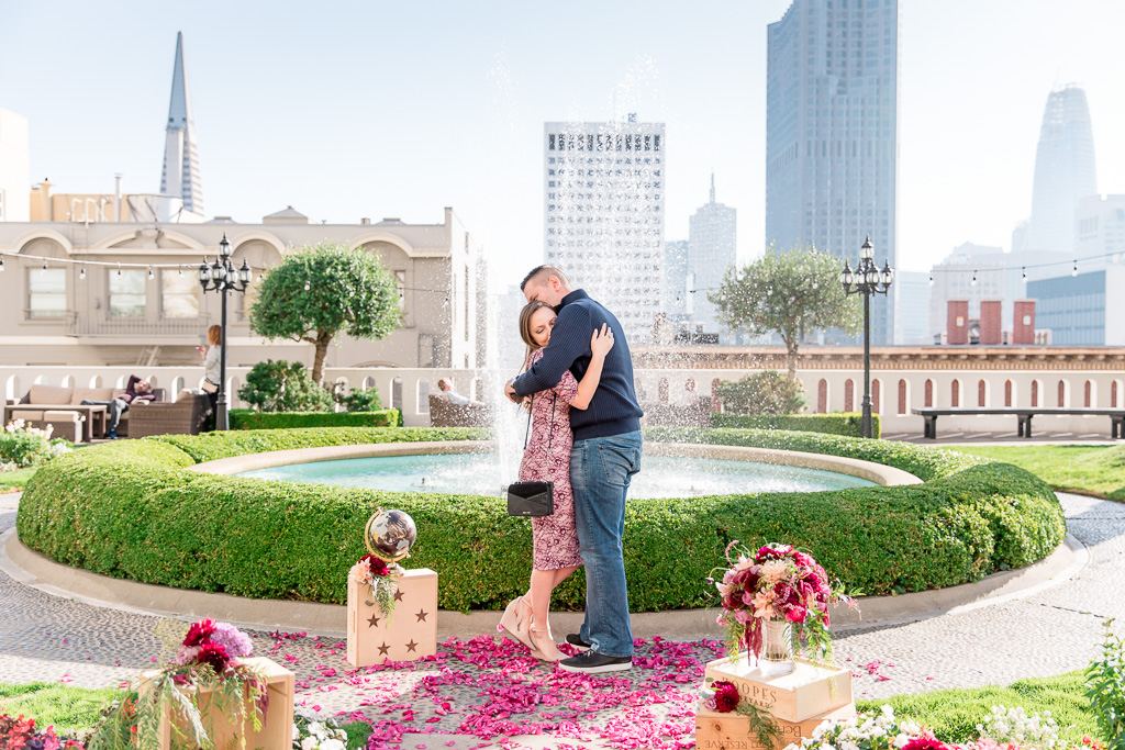 surprise marriage proposal at the historic fairmont hotel with san francisco skyline in the background