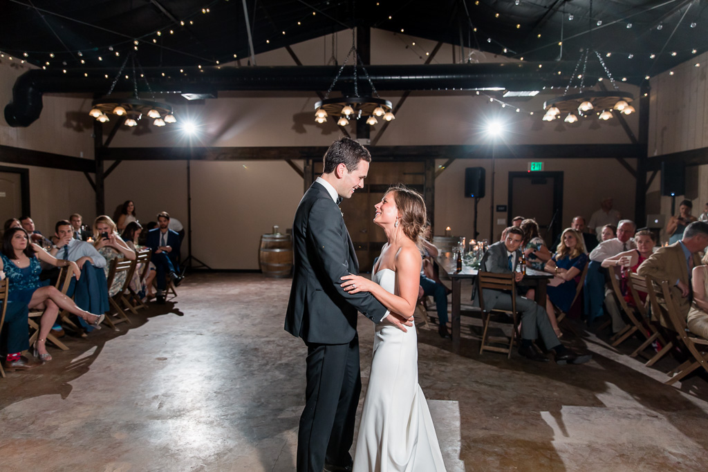 a romantic first dance inside the barn