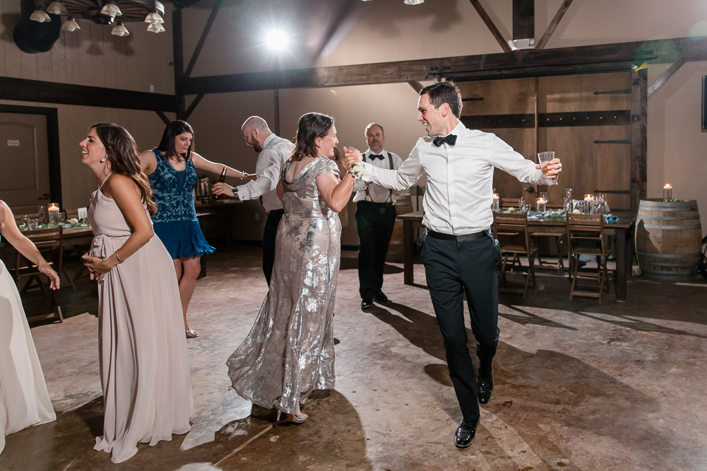 groom dancing happily with his mother