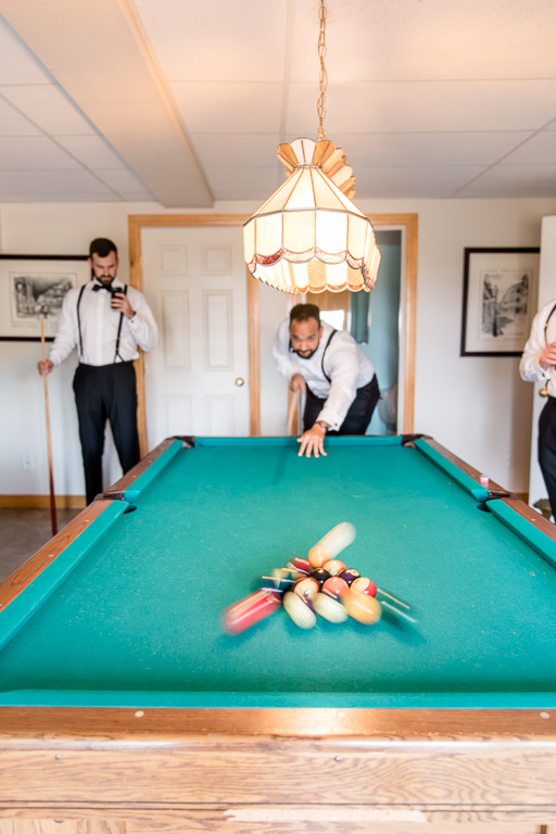 groomsmen and groom playing pool when getting ready