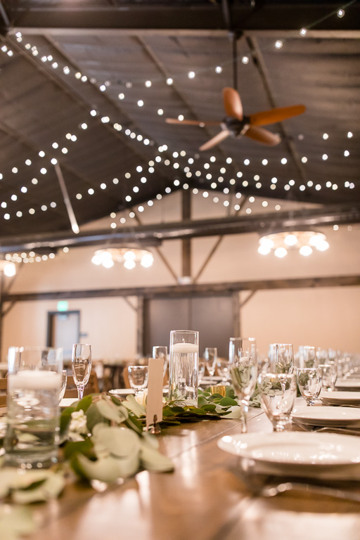 floating candles and string lights for a beautiful barn wedding reception
