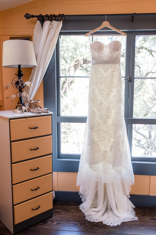 wedding gown hanging by the window