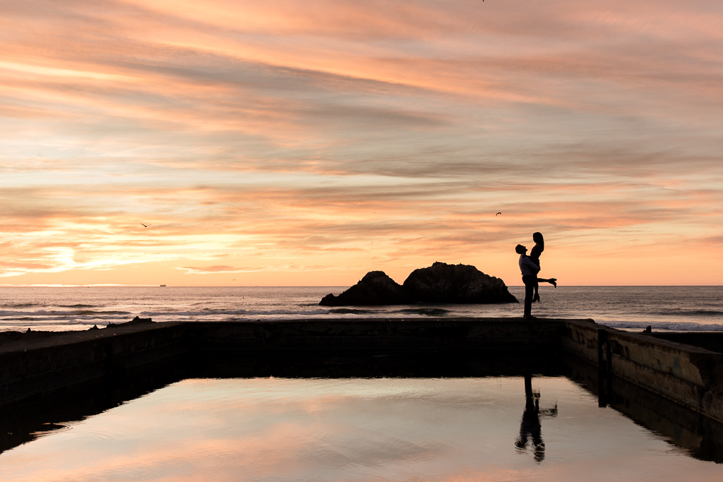 dramatic sunset engagement photo at sutro baths lands end