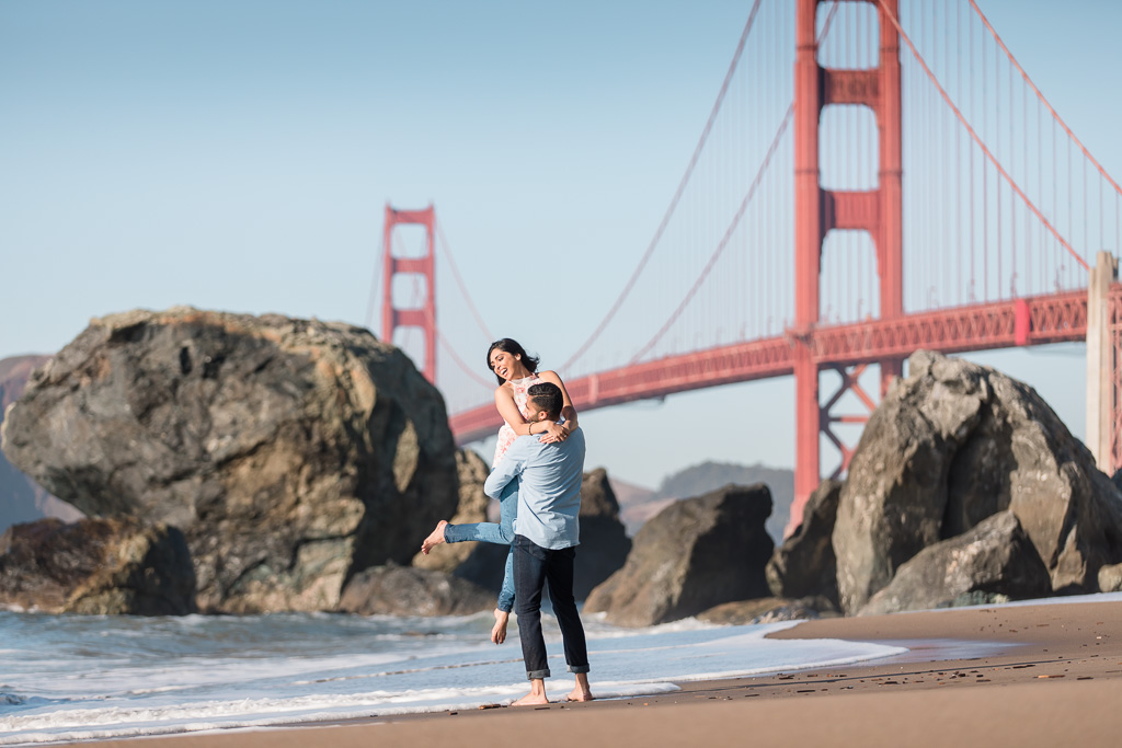 silly Golden Gate Bridge beach engagement photo