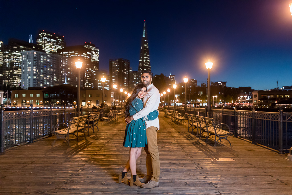 Pier 7 nighttime engagement photo with San Francisco city night skyline