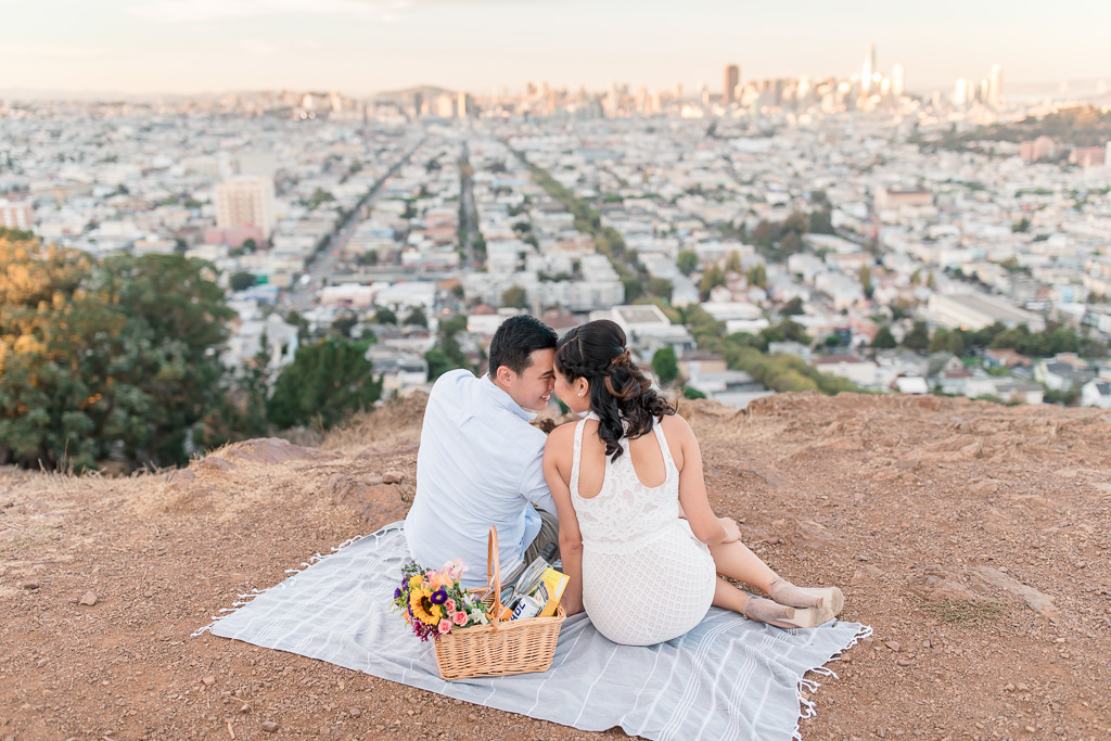 cute couple looking down on a San Francisco urban sunset