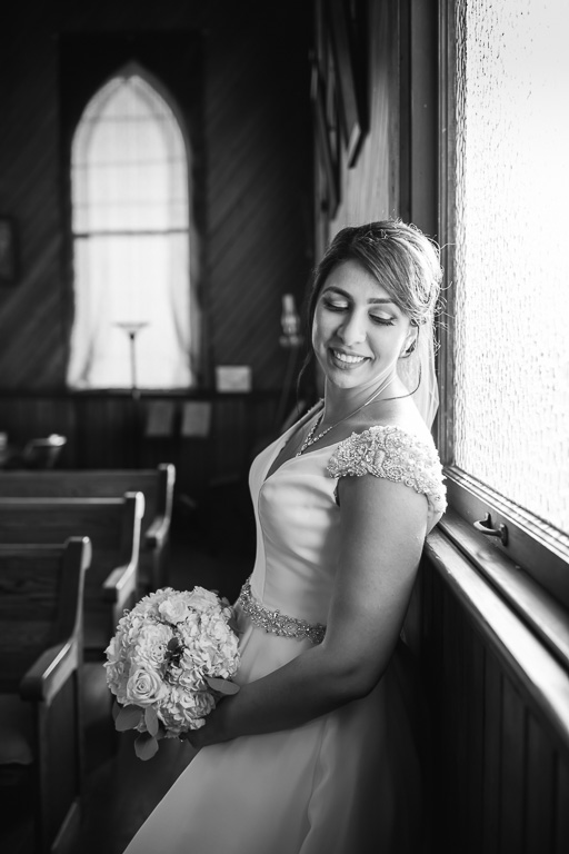 black and white portrait for the bride inside the cute tiny church