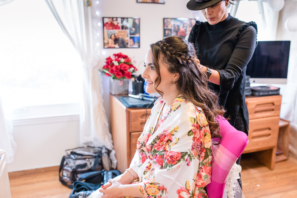 bride getting her hair done in a bridal robe