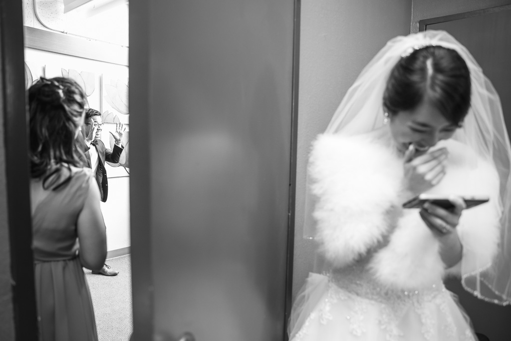 bride laughing hard from inside the room