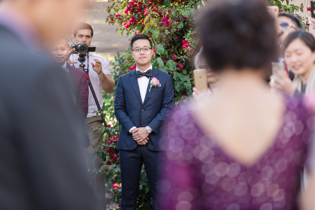 groom sees his bride walking down the aisle
