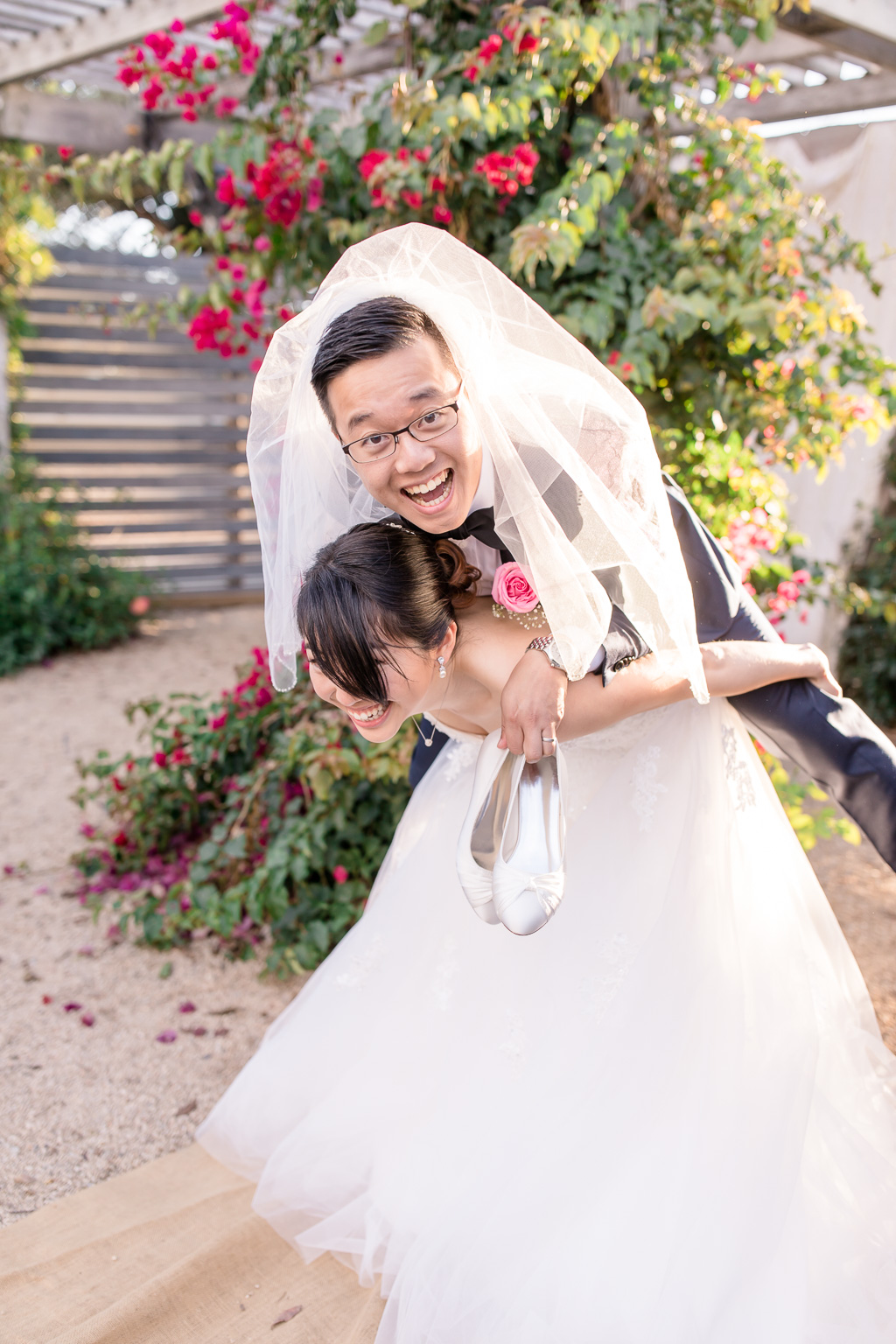 hilarious photo of the bride carring the groom on her back