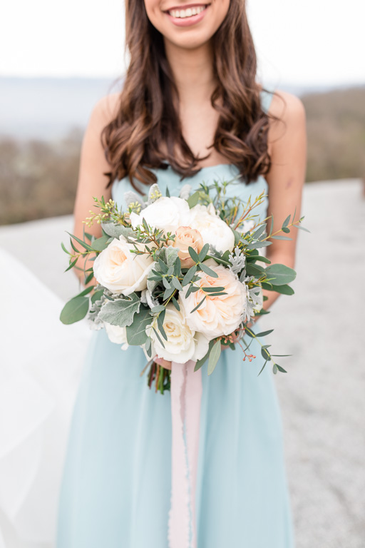 mint bridesmaid dress with a pastel color bouquet