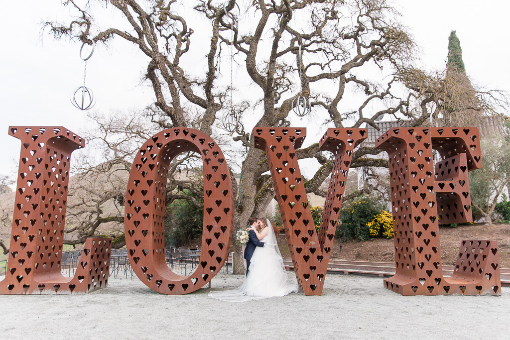 portraits with the giant metal love sign at willow heights mansion