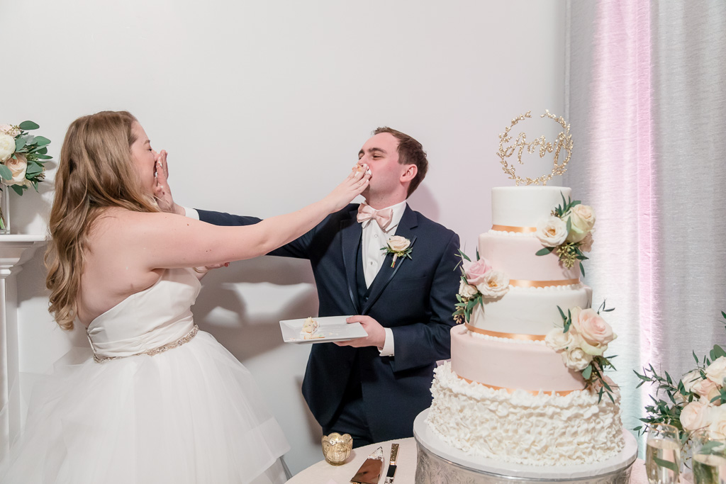 smashing the wedding cake onto each other's faces