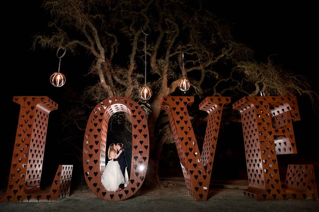 a beautiful night photo with the giant metal love sign for our bride and groom at willow heights mansion
