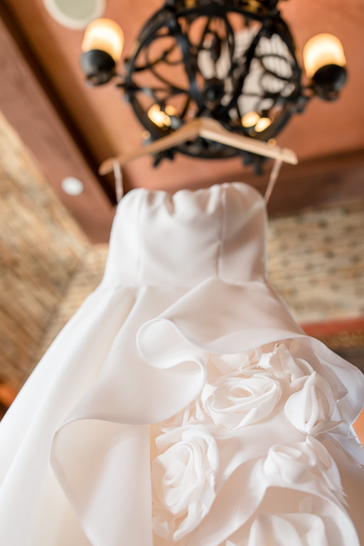 wedding dress hanging on a chandelier