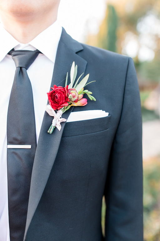 red and cream wedding boutonniere closeup