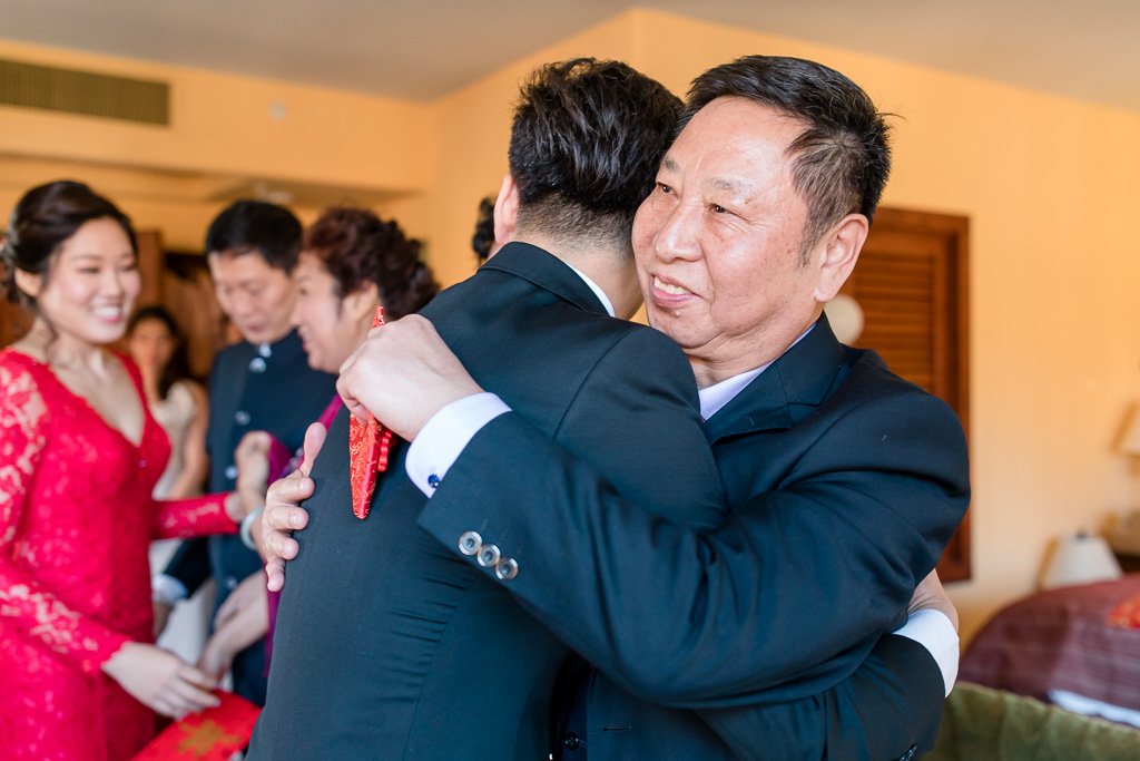 groom hugging his father