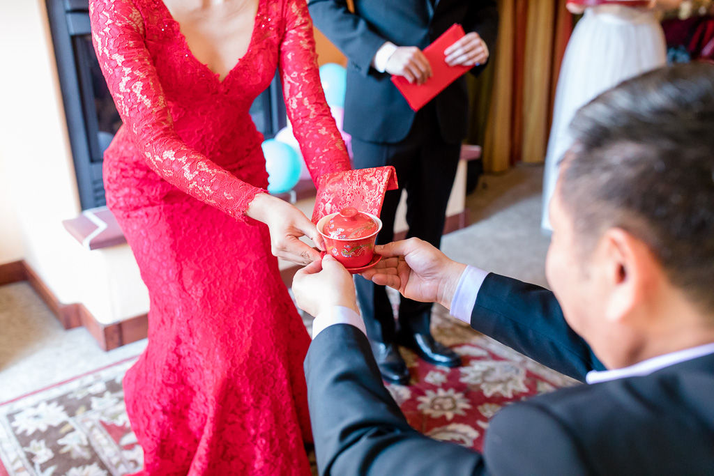 bride receives red pocket from father-in-law