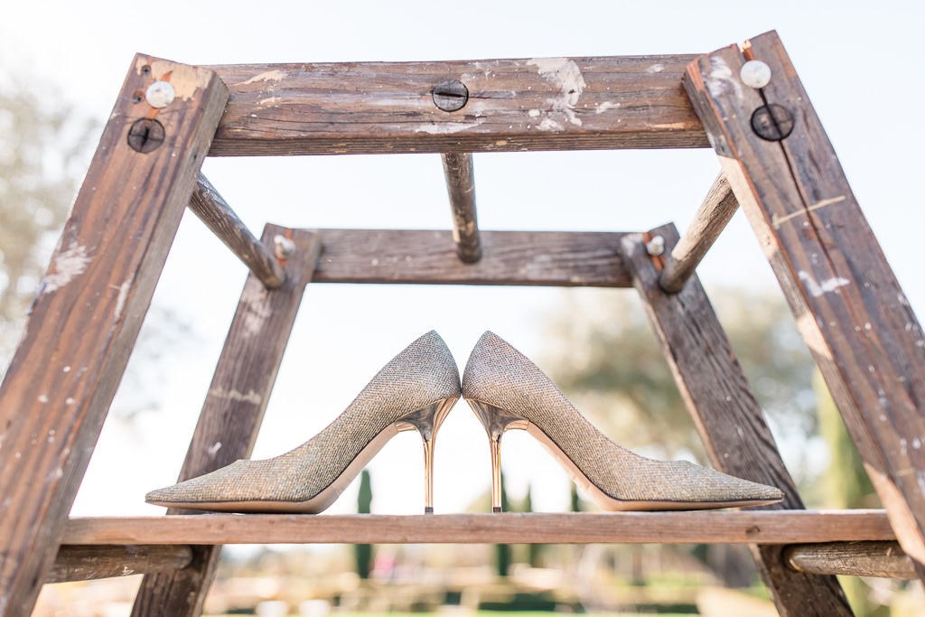 jimmy choo wedding shoes on a rustic ladder