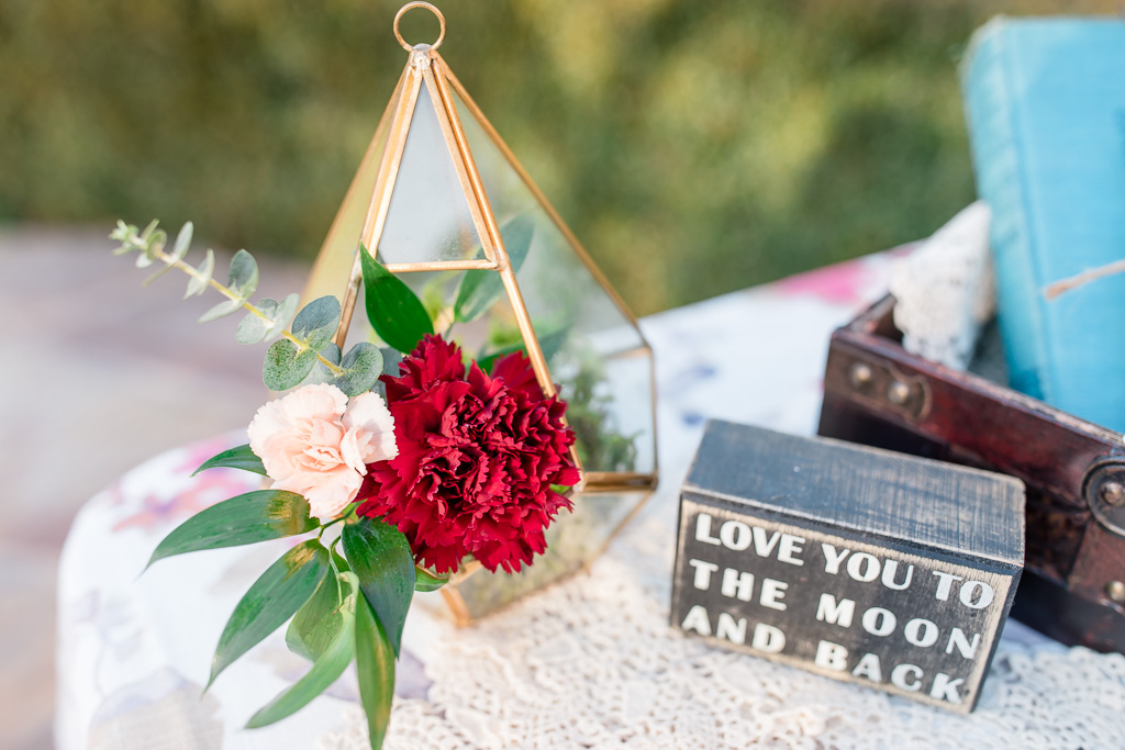 pretty little floral arrangement on the sign in table