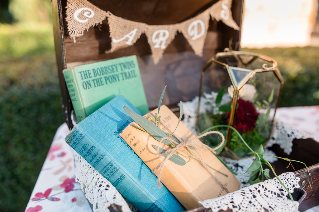 wedding sign in table suitcase with vintage books and flowers