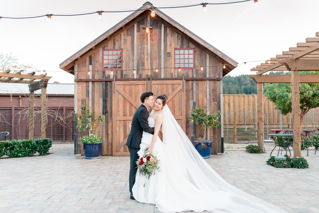bride and groom in front of the regale winery barn