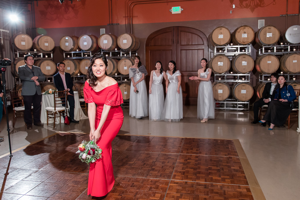 bouquet toss in the Regale winery barrel room