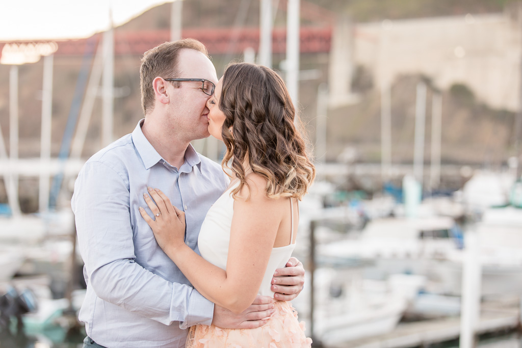 couple kissing in front of yachts boat background at Cavallo Point