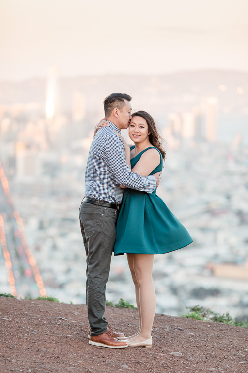 kissing on the forehead against a twilight San Francisco backdrop