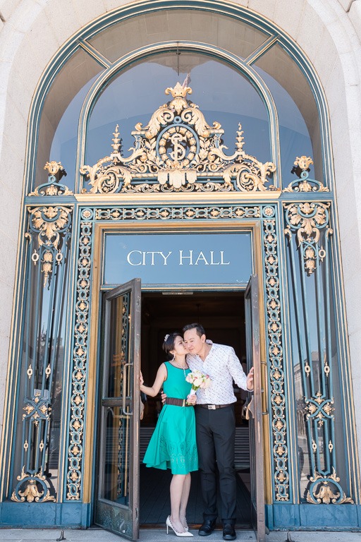 Kissing under San Francisco City Hall front door sign