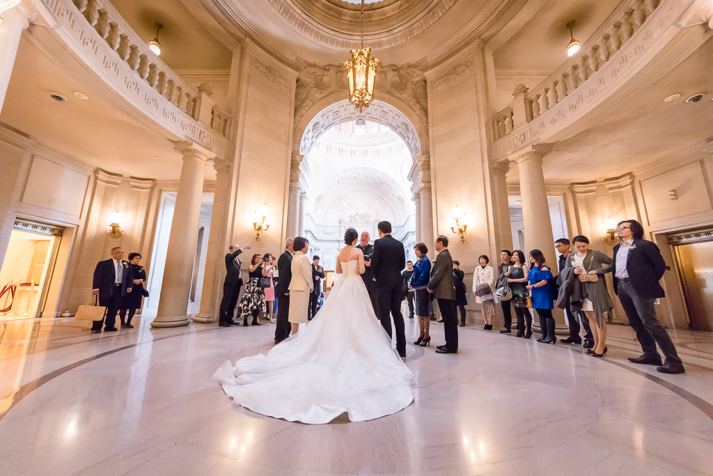 wedding guests circled around couple at San Francisco City Hall