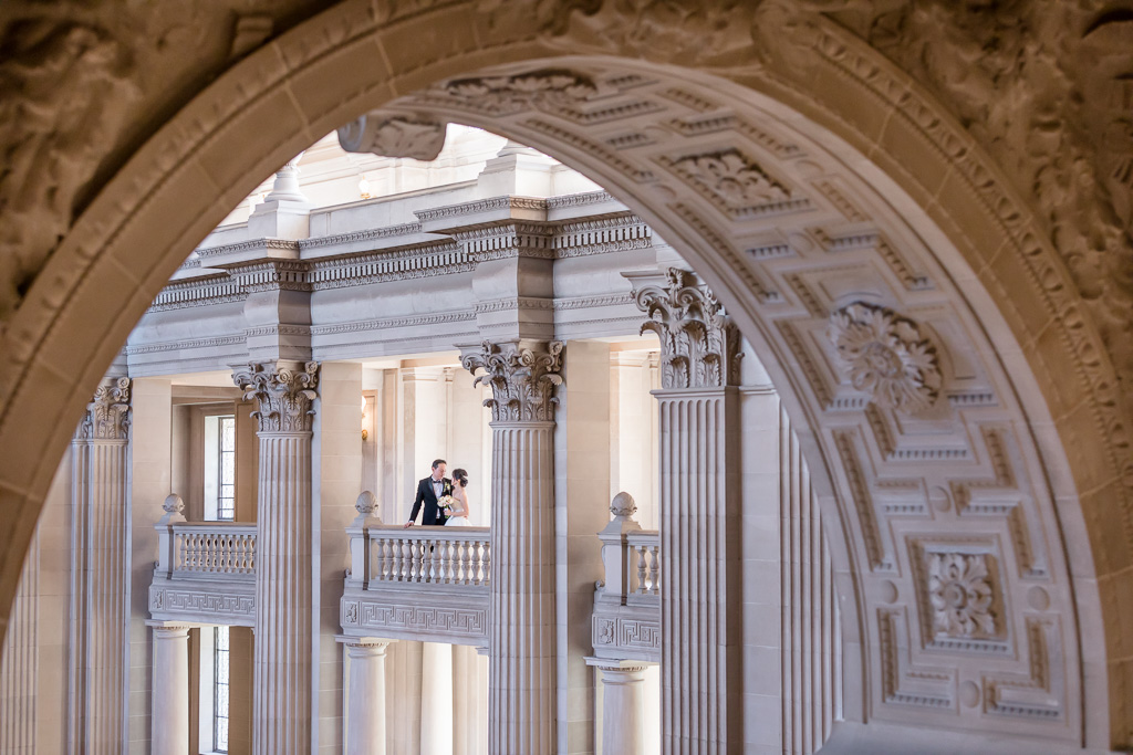 zoomed out photo of bride and groom at San Francisco City Hall