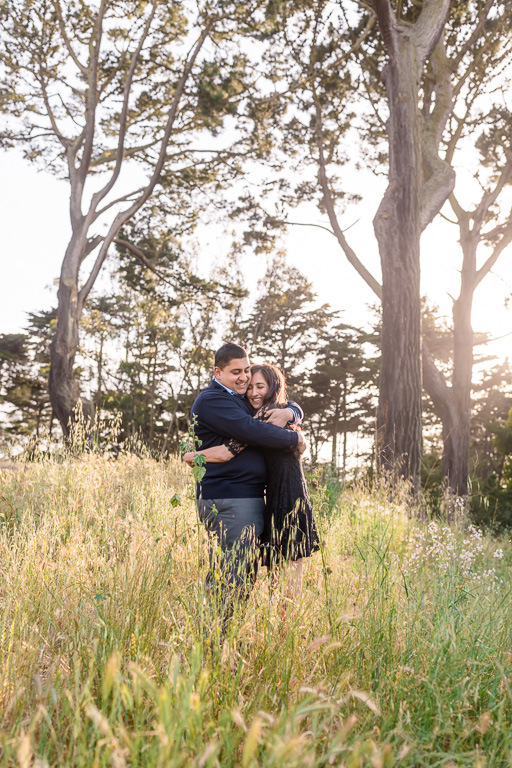sun beams shining through trees and grass engagement picture