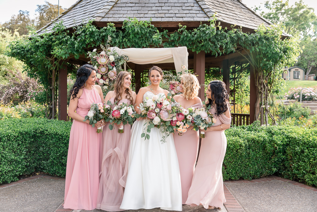a cute bridesmaids group photo in front of the gazebo