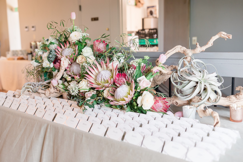 Escort card table decorated with exotic South African flowers