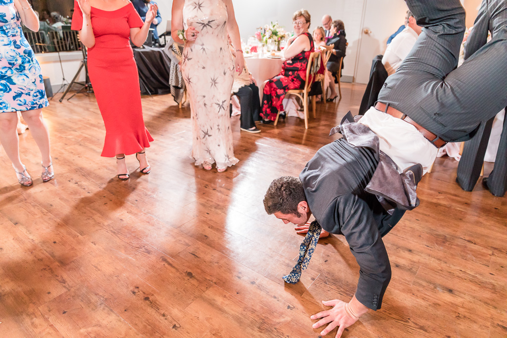 Wedding guest doing a handstand on the dance floor