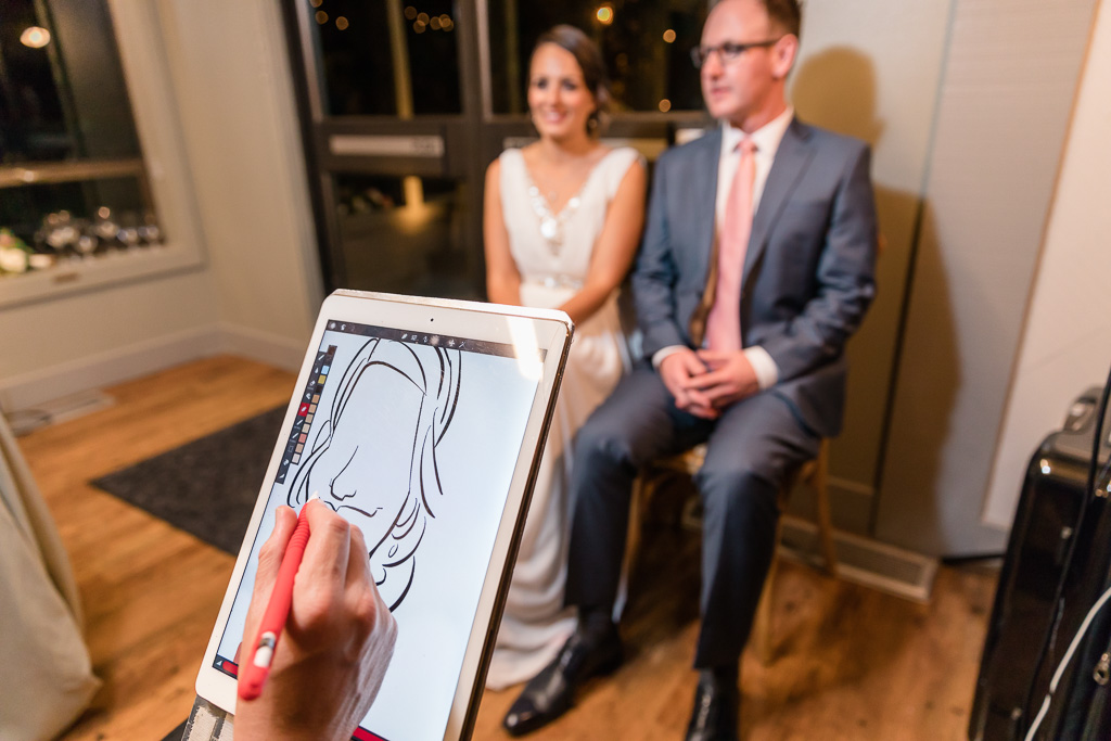Cartoonist drawing caricatures of the bride and groom