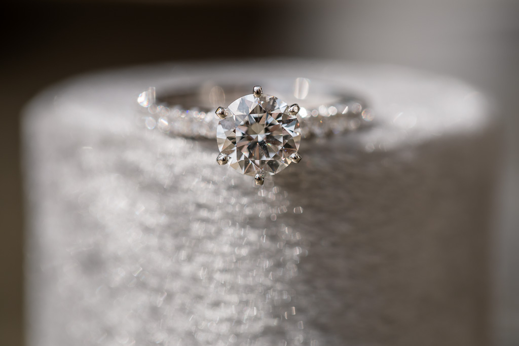 soft macro photo of diamond ring on round gray velvet box