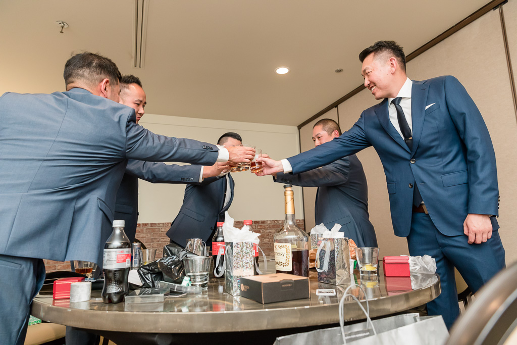 cheers - groom and groomsmen drinking whiskey before wedding
