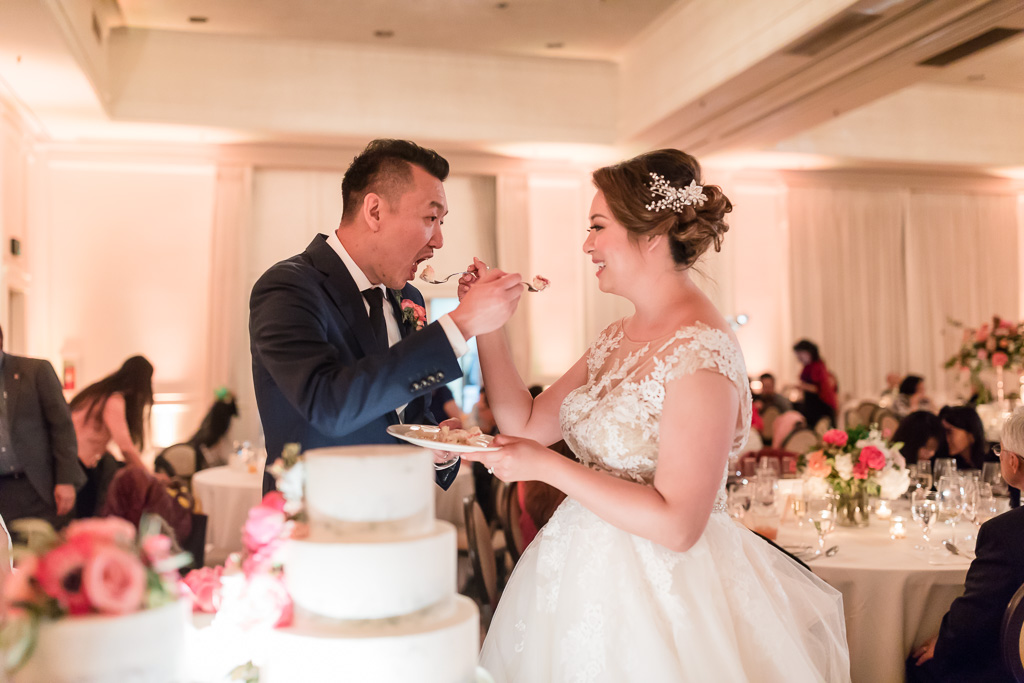 bride and groom peacefully feeding each other slices of cake