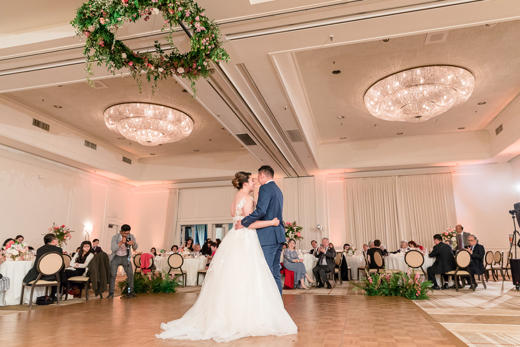 first dance with floral chandelier hanging overhead
