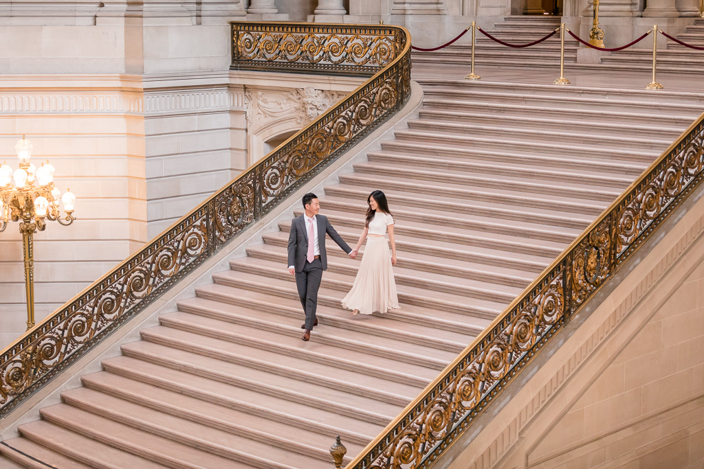 wedding portrait of bride and groom walking on grand staircase