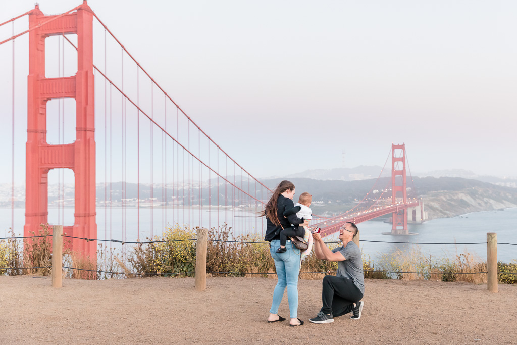 surprise engagement proposal on top of the Golden Gate Bridge and San Francisco city skyline
