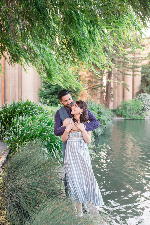 engagement photo at palace of fine arts by the pond