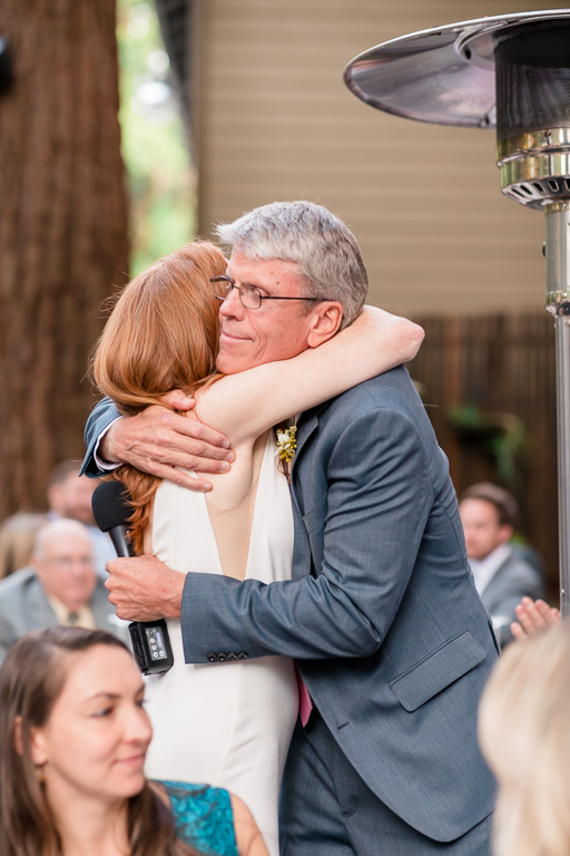bride hugging her dad at the reception